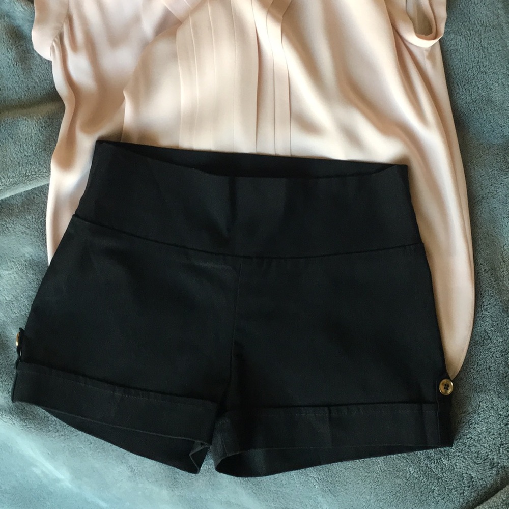 Black shorts with a gold button on the side